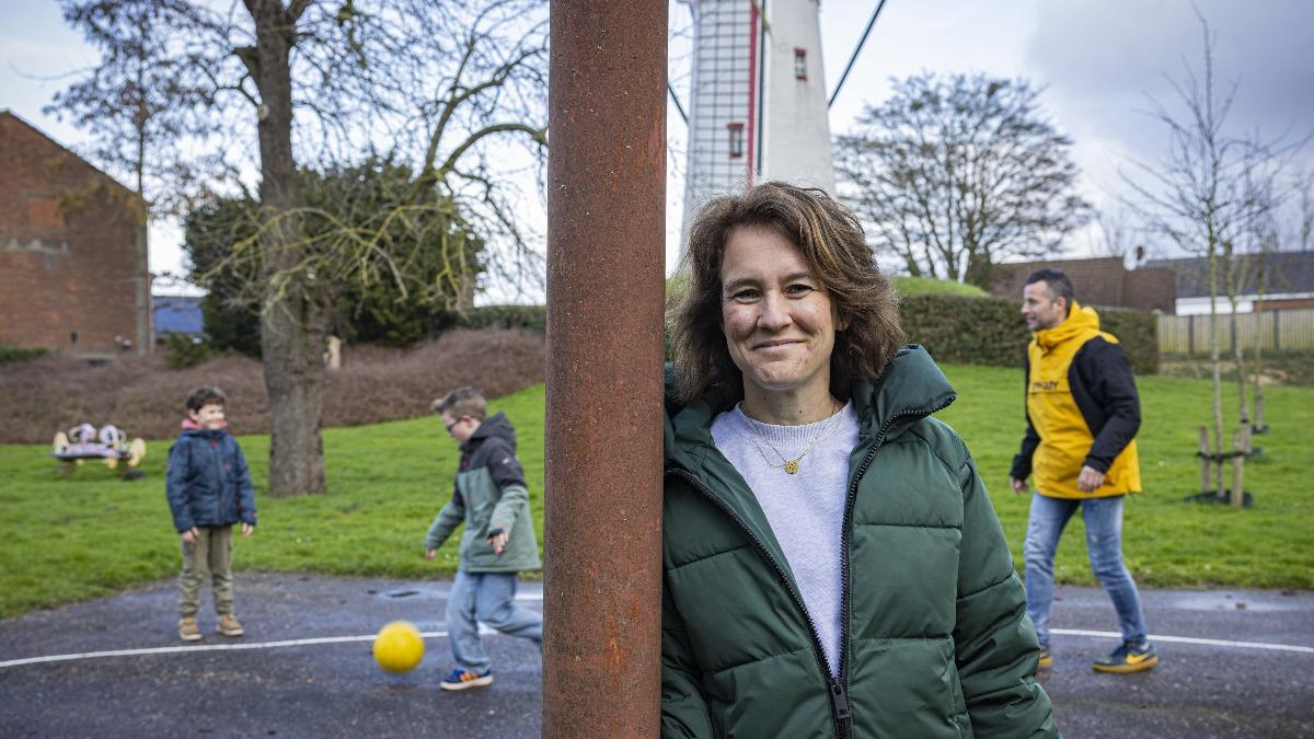 Bianca tegen een paal met haar kinderen en man op de achtergrond