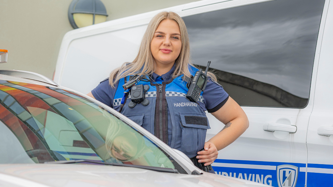 Kristien als boa tussen geparkeerde auto's