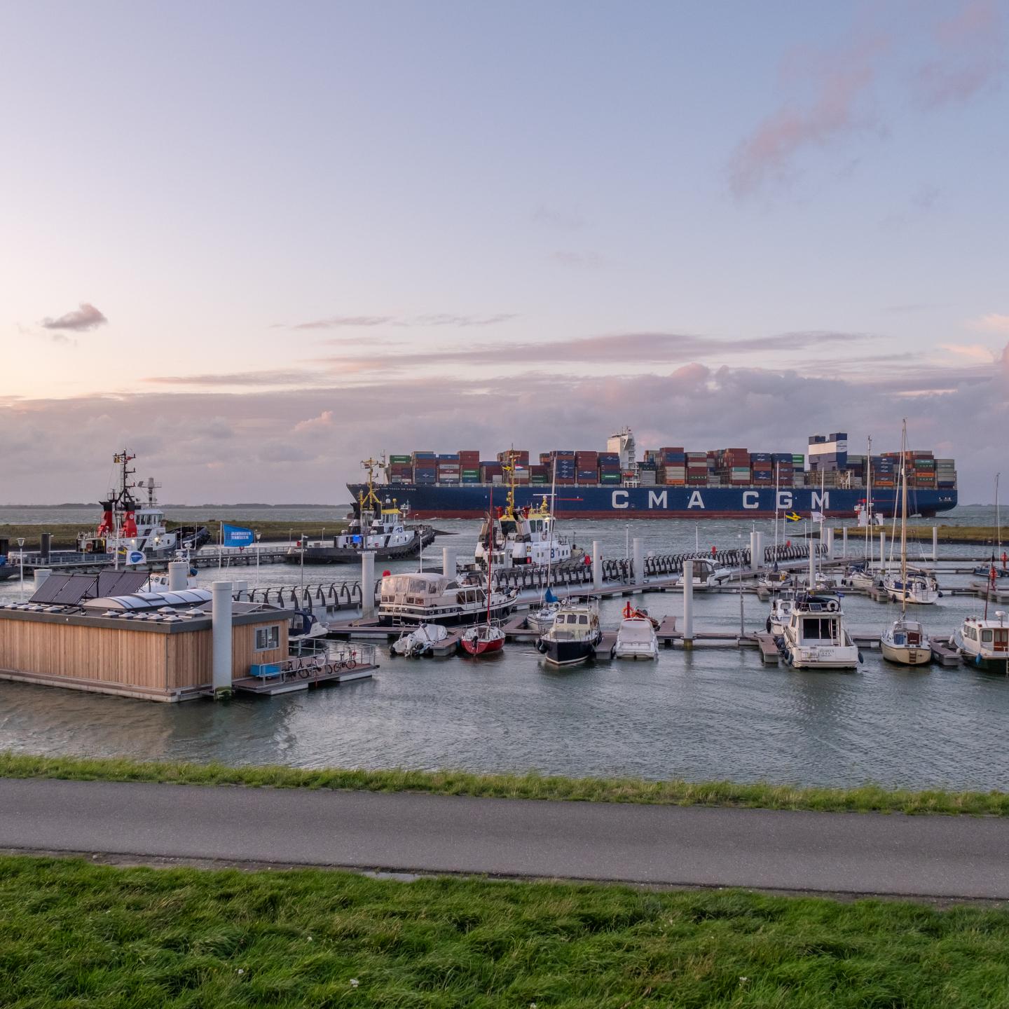 Jachthaven van Terneuzen met op achtergrond een groot passerend containerschip
